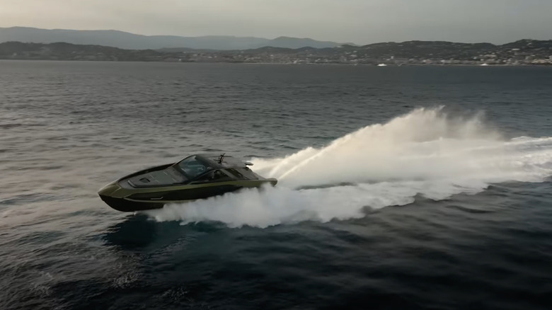 A Tecnomar for Lamborghini 63 yacht on the water, a sizable spray trailing after it.