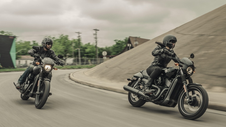 Two riders cornering on Harley-Davidson Street 750 bikes