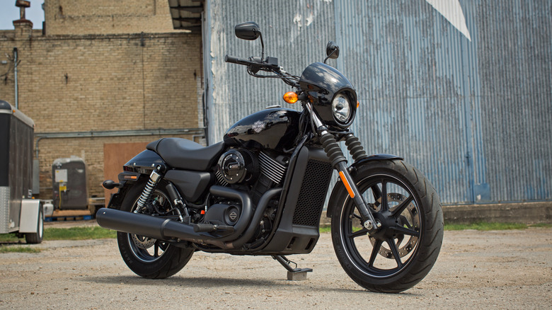 Black Harley-Davidson Street 750 parked on dirt in front of buildings