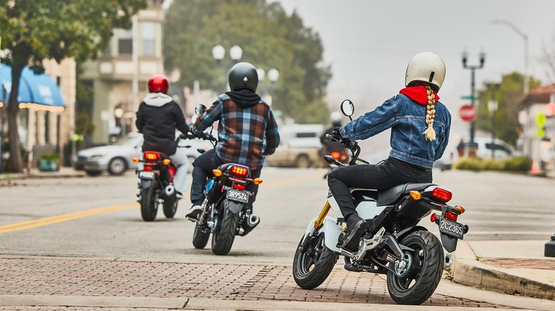 Three riders on Honda Grom's in the city