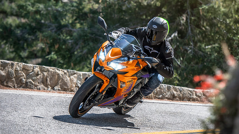 Orange Kawasaki Ninja 650 cornering on a mountain road