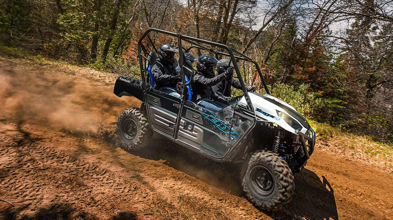 People riding in Kawasaki Teryx 4