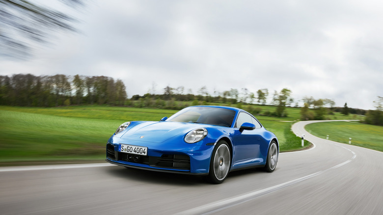 Blue Porsche 911 Hybrid driving