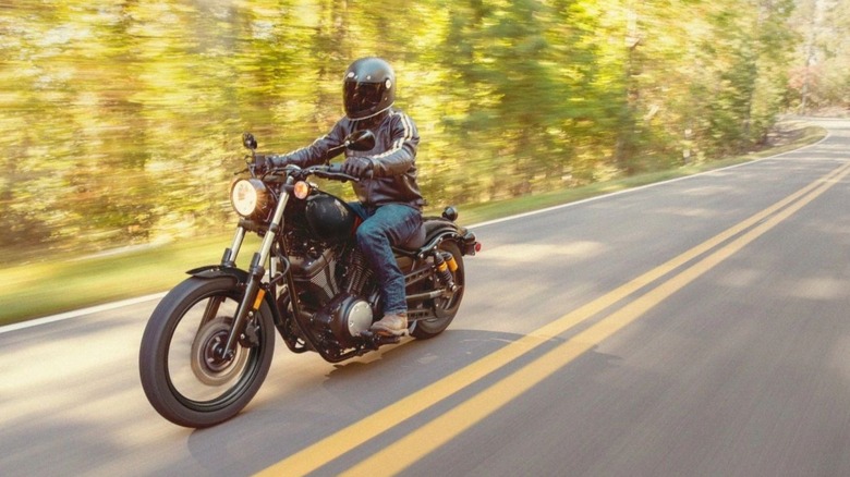 A man riding a Yamaha R-Spec through a forest road