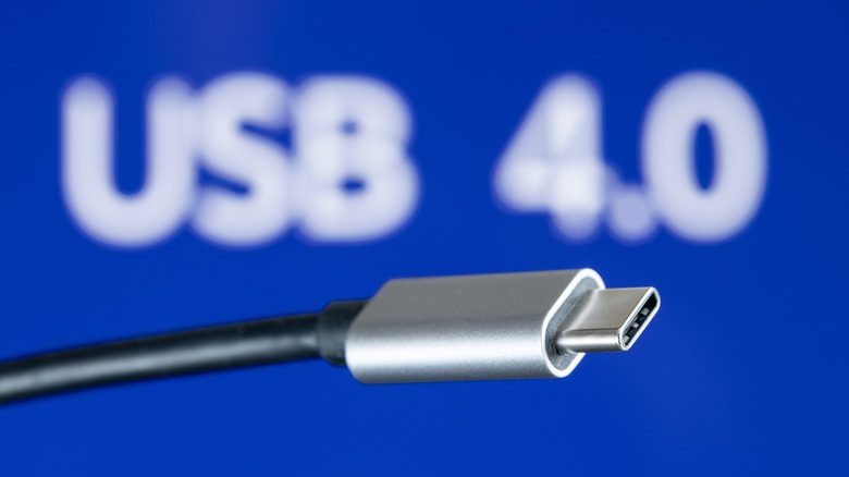 USB4 plug cable on blue background with USB 4.0 text