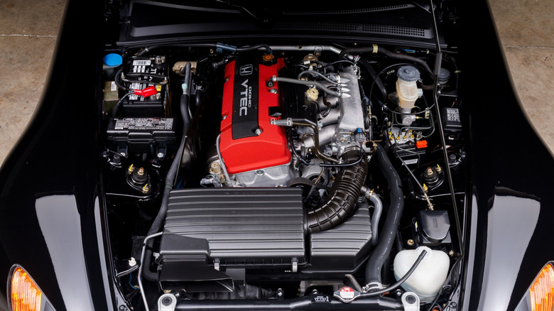 The F20C engine under the hood of a black Honda S2000