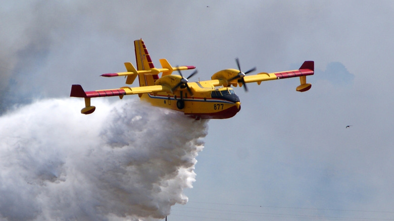 Super Scooper aircraft dropping water on wildfire.