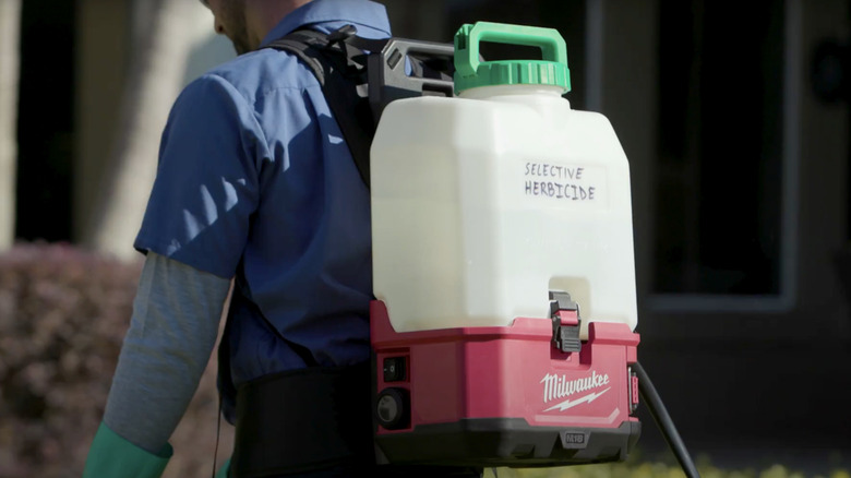 man wearing Milwaukee 18V Backpack Sprayers