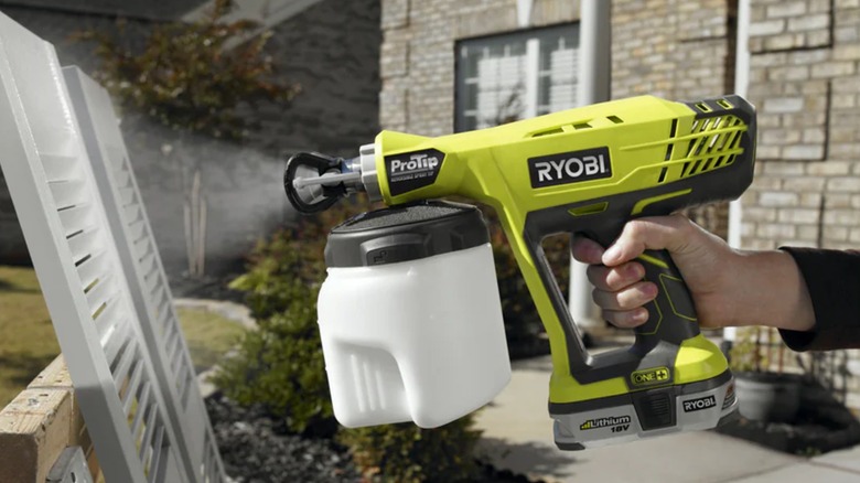 person using Ryobi paint sprayer