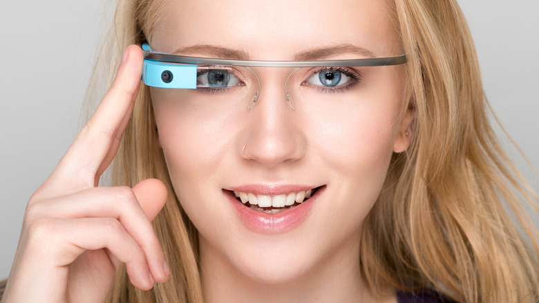 A woman wearing a blue pair of Google Glass
