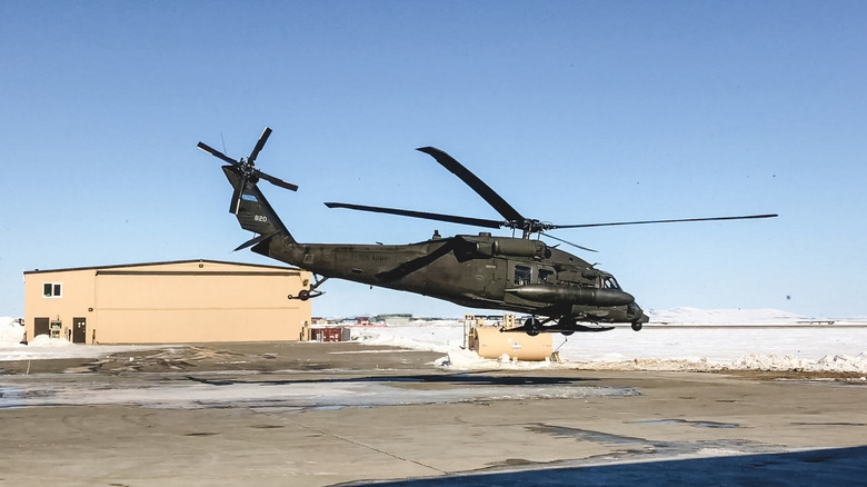 An army helicopter during liftoff.