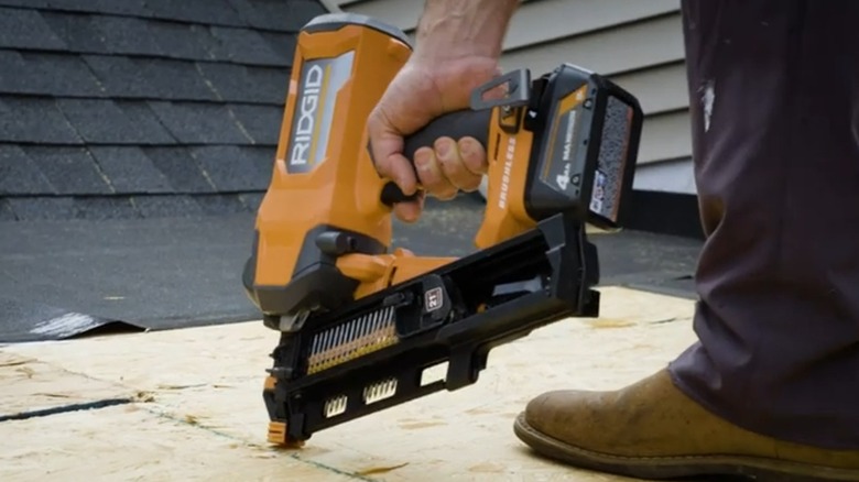 A person using a Rigid framing nailer