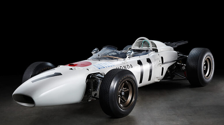 Front 3/4 view of 1965 Honda F1 car with V12 engine in studio