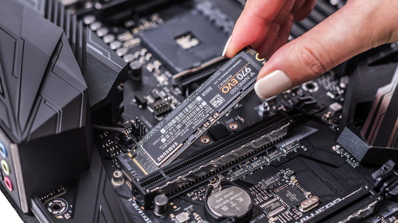 samsung evo 970 ssd being plugged into a system