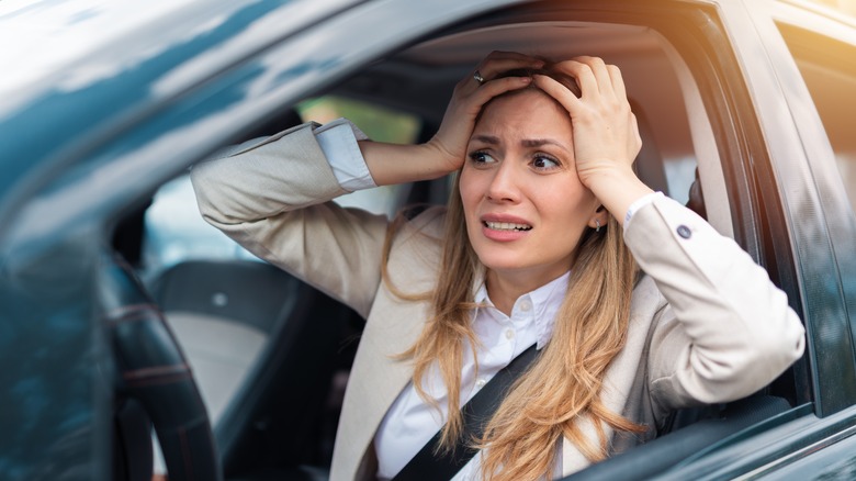 Visibly upset woman in car