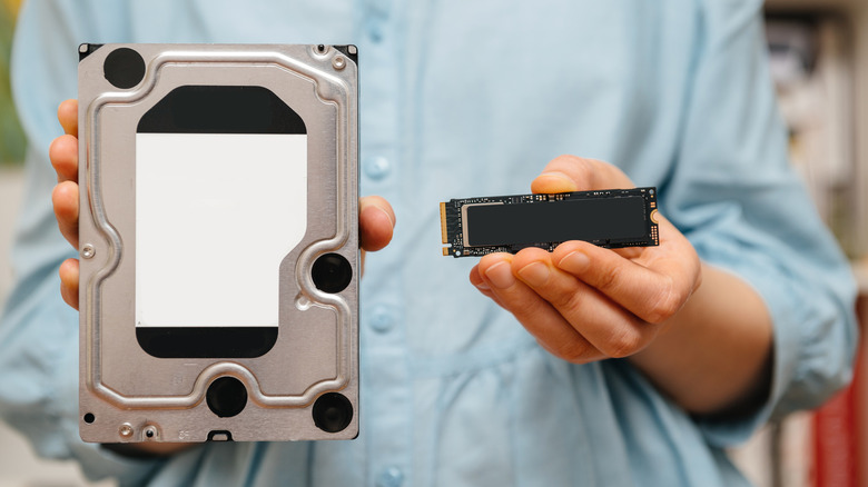 A person holding an HDD and a PCIe NVMe SSD in each hand