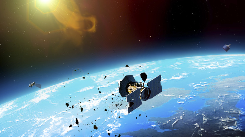 An illustration of broken satellite and space debris orbiting above earth.