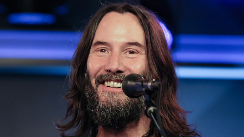 Keanu Reeves smiling on stage