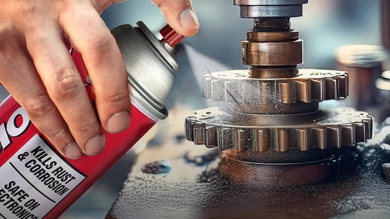 Man spraying rust inhibitor on gears