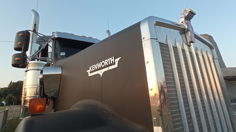 Kenworth W900 closeup on the Kenworth logo badge on side of the hood.