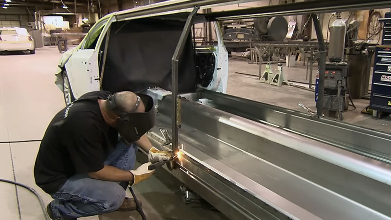 Men fabricating Chrysler 300 limo