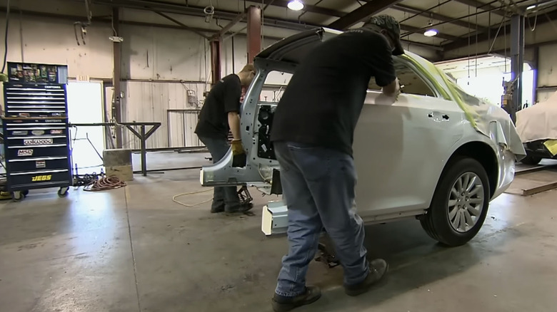 Men building Chrysler 300 limo
