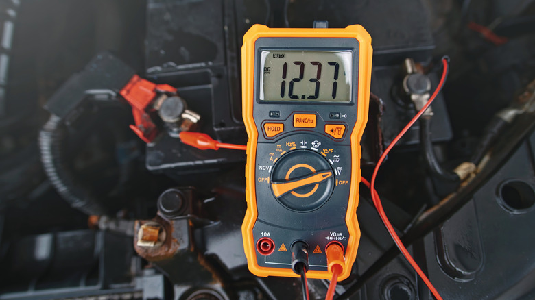 Checking car battery voltage with a multimeter