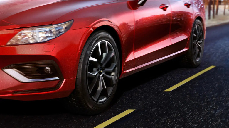 Michelin Primacy Tour A/S tires on a moving red car with gray rims