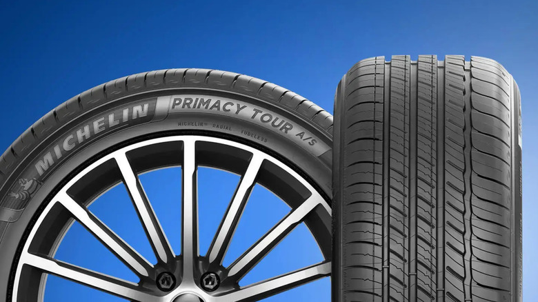 Closeup of the Michelin Primacy Tour A/S tire against a blue background