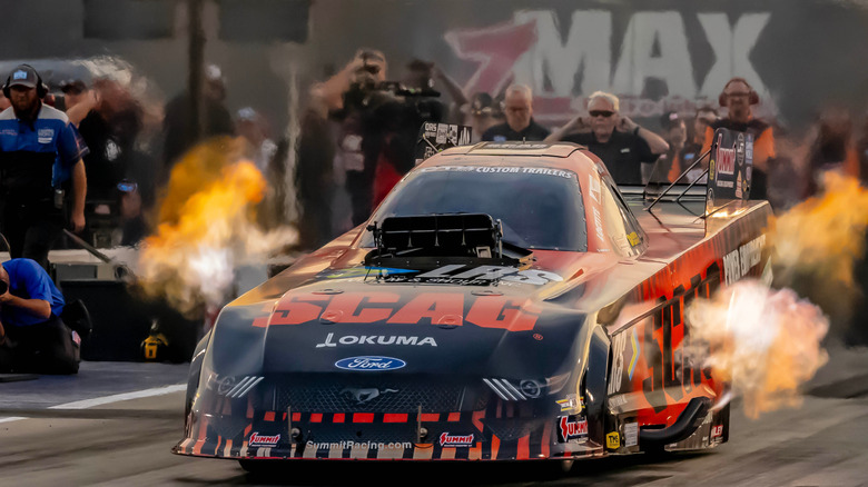 Mustang funny car spitting flames on a drag strip