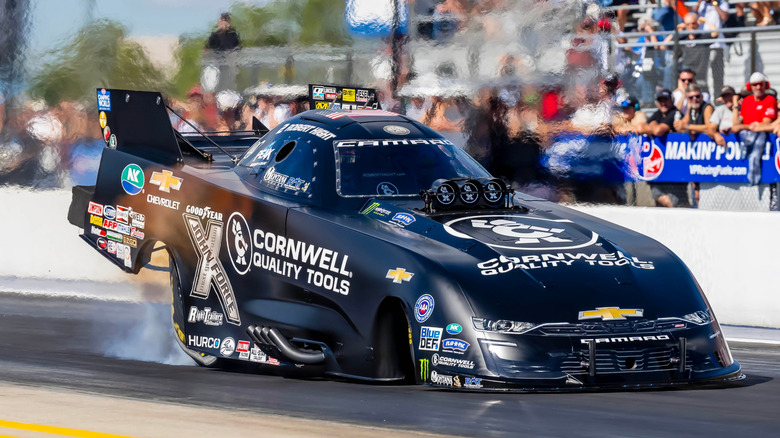 Black Chevrolet Camaro funny car on a drag strip