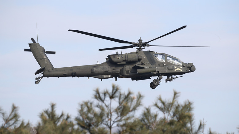 Helicopter flying above tree line