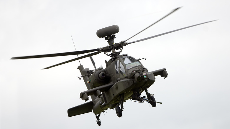 AH-64 Apache helicopter banking right in flight