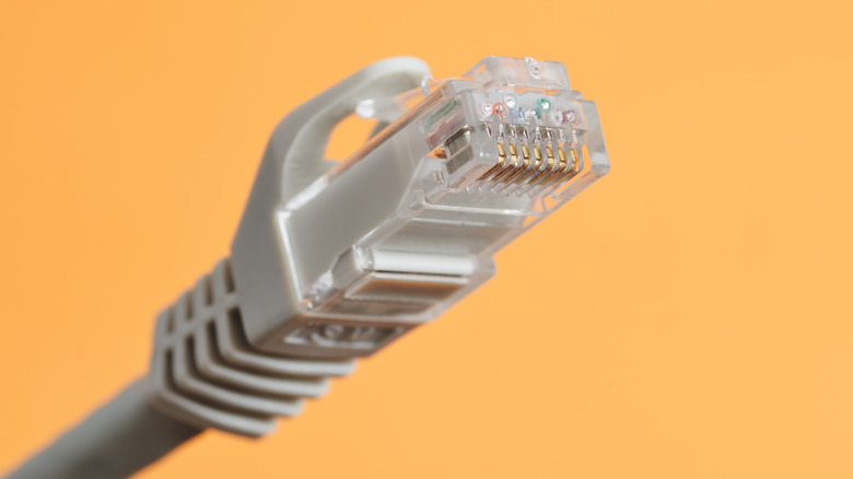 RJ45 connector against a yellow background