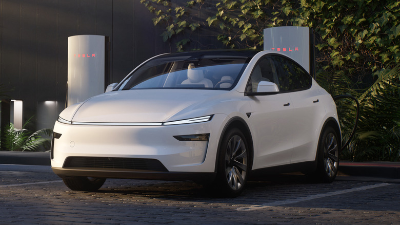 A white Tesla Model Y parked at a Supercharger