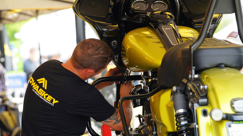 A mechanic repairing a Harley-Davidson motorcycle