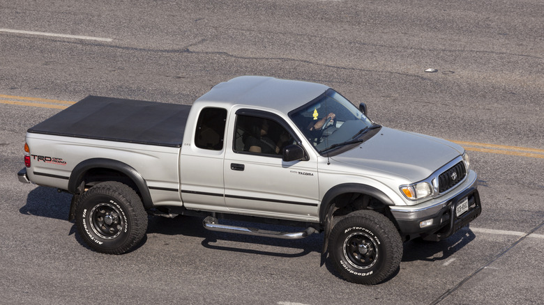 Overhead-side shot of a silver Toyota Tacoma TRD Off-Road on the freeway