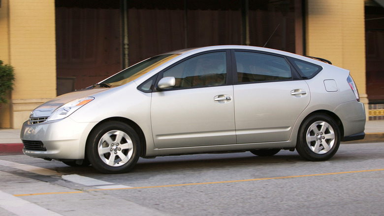 Side profile of a parked second-generation Toyota Prius in front of a building