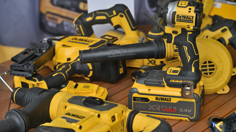 Several DeWalt tools on a table.