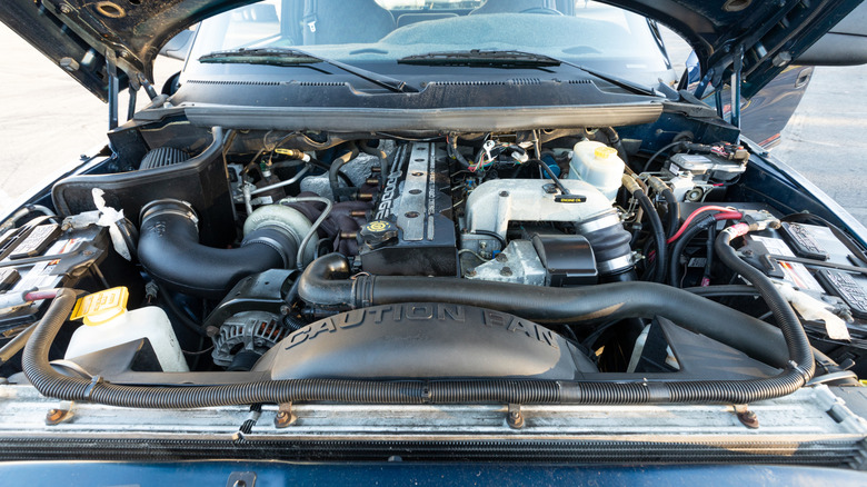 Car with hood open showing turbo diesel engine