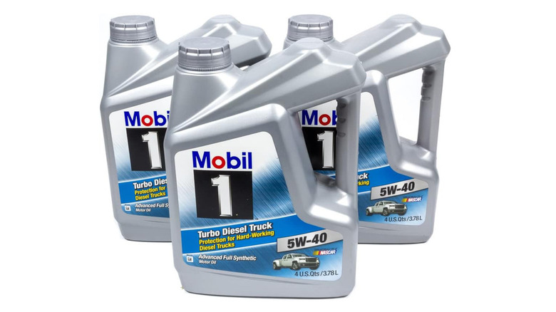 Three Mobil 1 Turbo Diesel Truck oil packs on white background