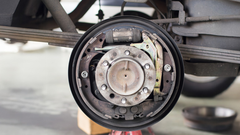 Close up of a drum brake with wheel drum removed, showing its internal components