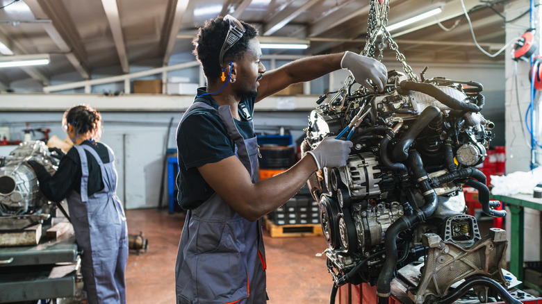 Mechanic working on car engine