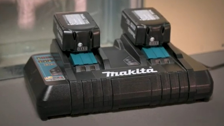 A Makita LXT dual charger on a table.