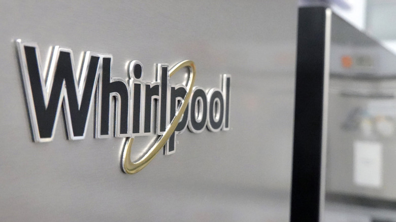 A silver Whirlpool refrigerator for sale inside an appliance store