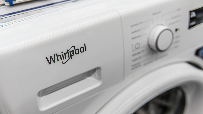 Whirlpool logo on the front of a washing machine.