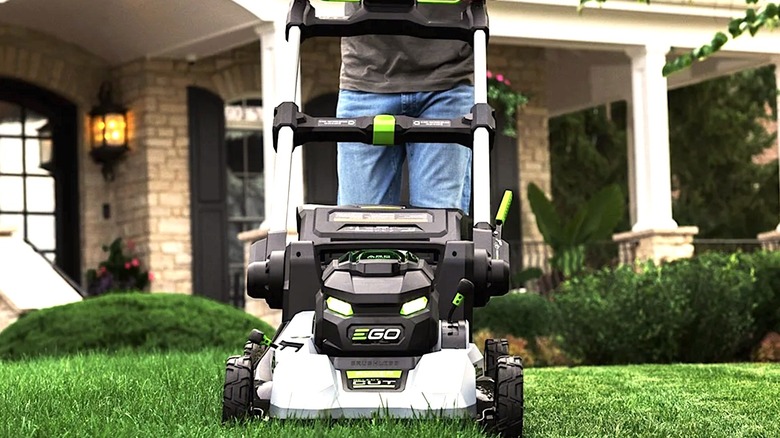 Person using an Ego mower to cut grass