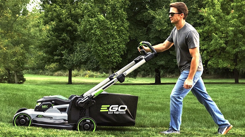 Man using Ego lawn mower to cut his grass