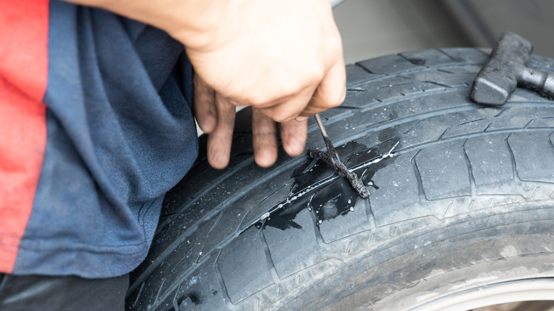 Mechanic inserting a tire plug
