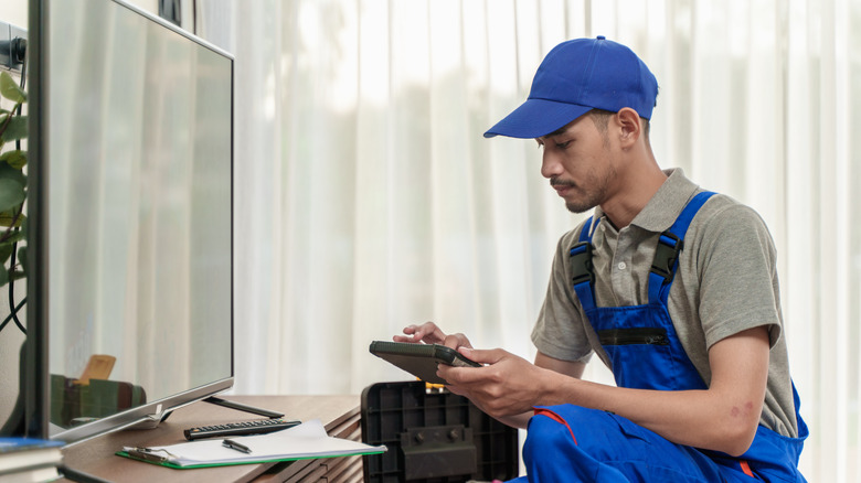 Technician servicing smart tv